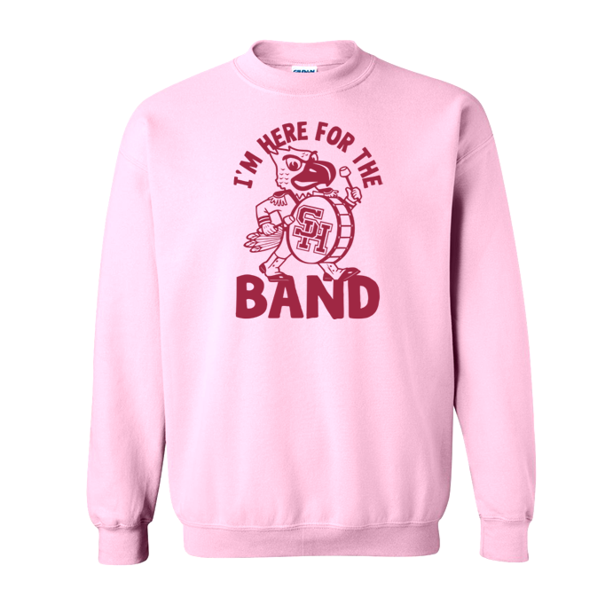 A light pink crewneck sweatshirt featuring a dark red graphic of a cartoon band member and the text 'I'M HERE FOR THE BAND' on the front, displayed against a solid white background.